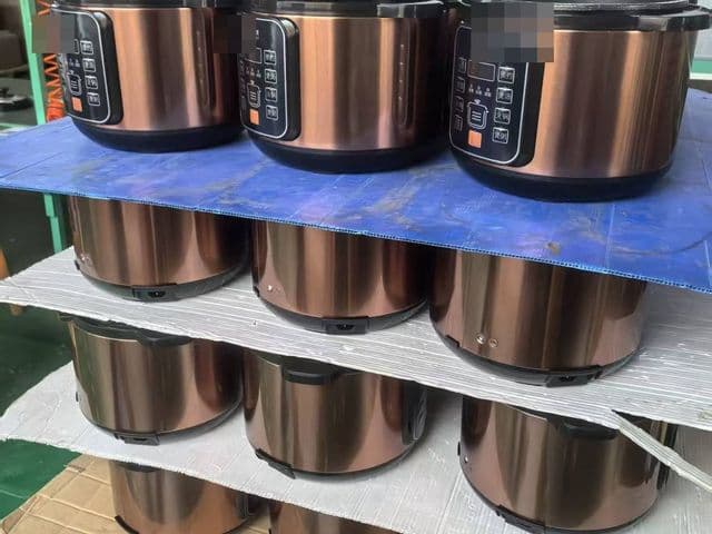 Finished rice cookers staged on racks inside a Chinese small-appliance factory