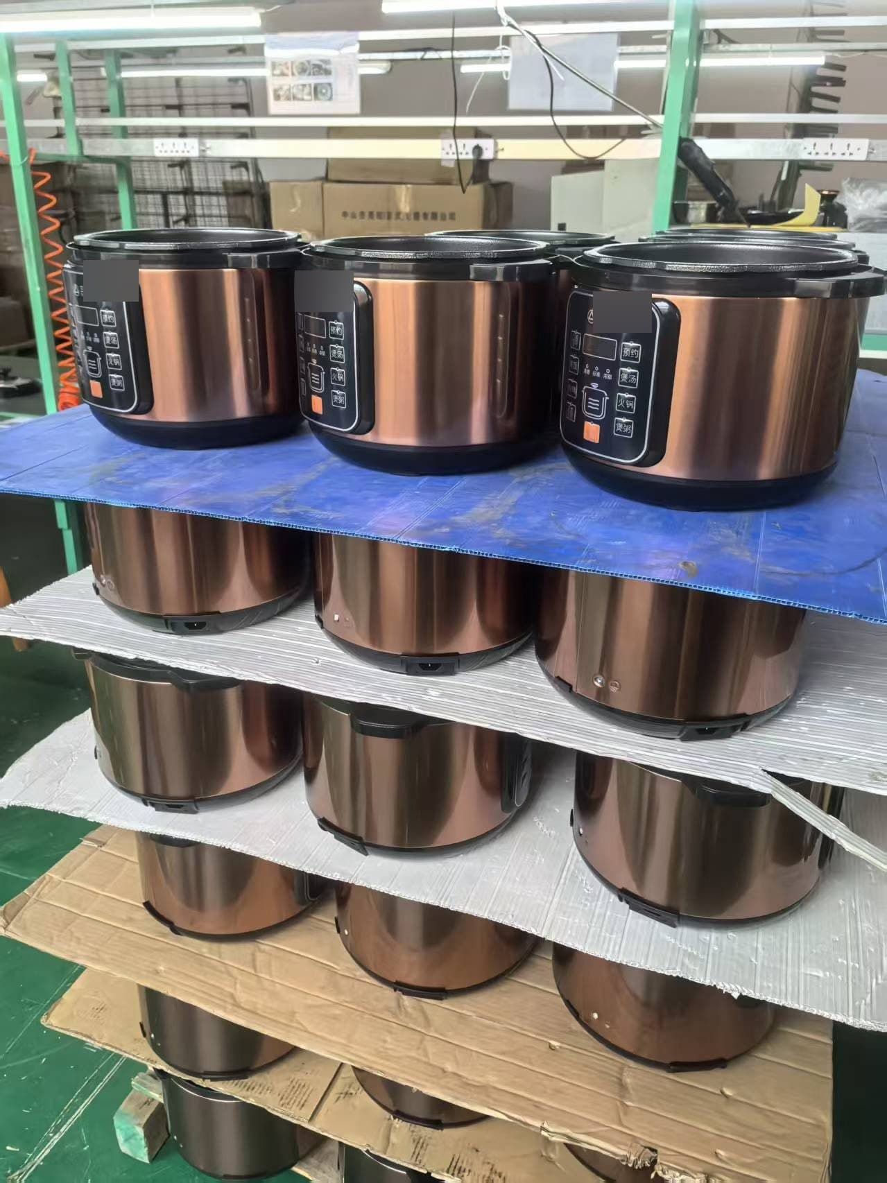 Stacked electric rice cookers at a Chinese appliance factory, photographed during a Tasman Global supplier visit