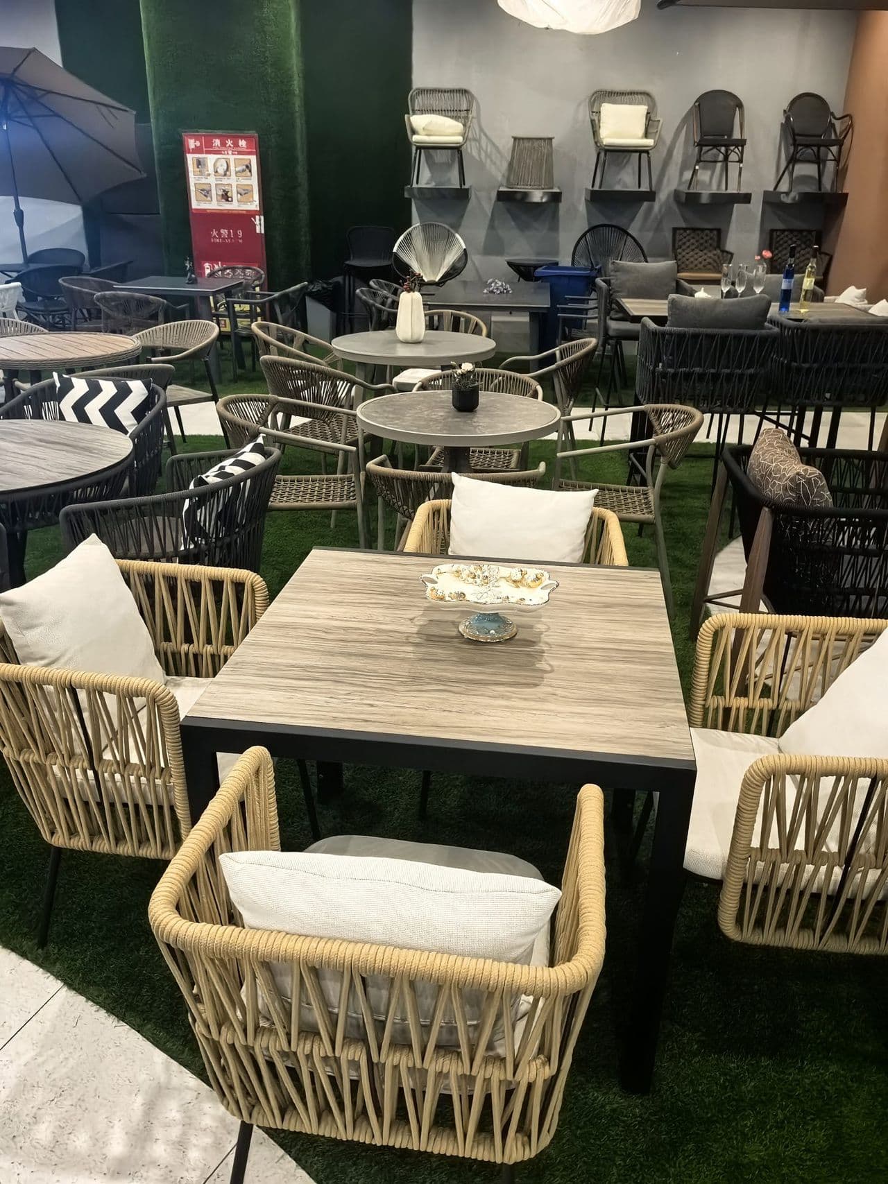 Colorful outdoor furniture showroom display with wicker chairs and tables